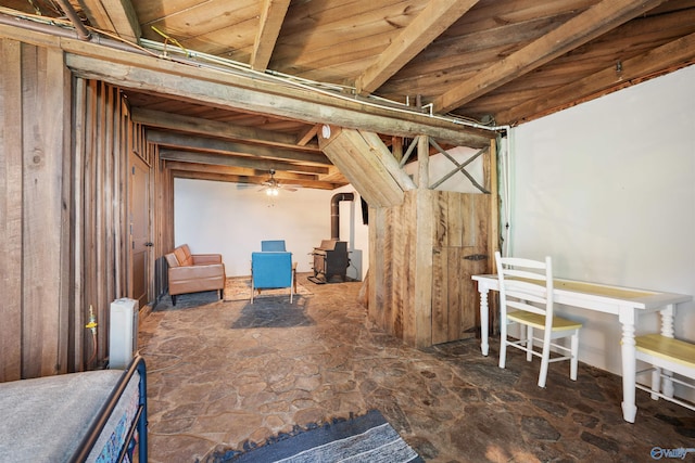 basement featuring stone flooring and a wood stove