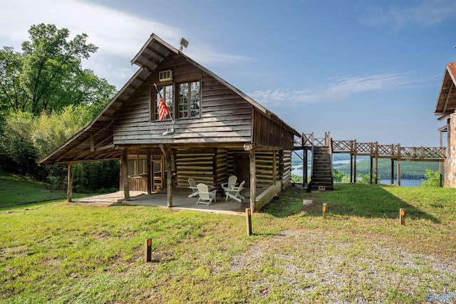 view of outbuilding with stairs and a water view
