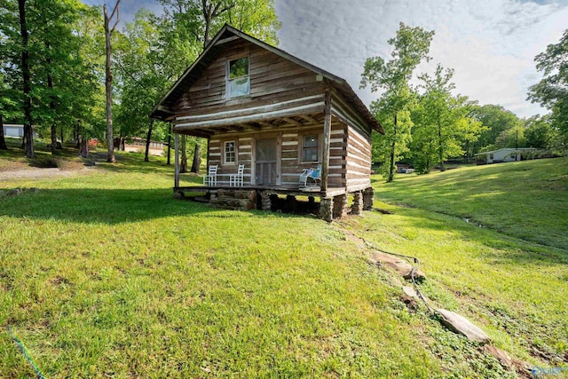 view of front of home with a porch and a front yard
