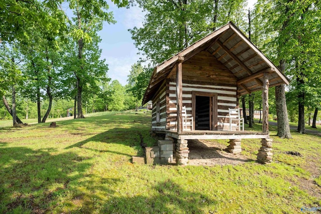 view of home's community with a lawn and an outbuilding