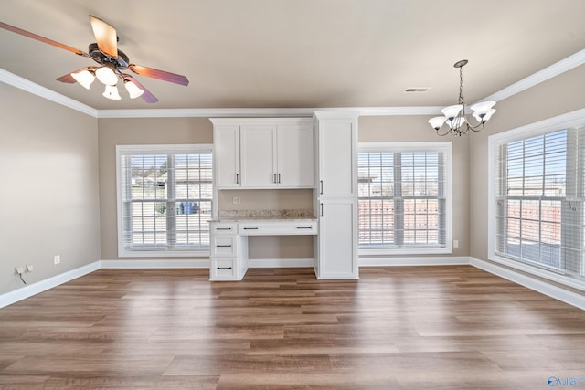 kitchen with ornamental molding, pendant lighting, white cabinets, and wood finished floors