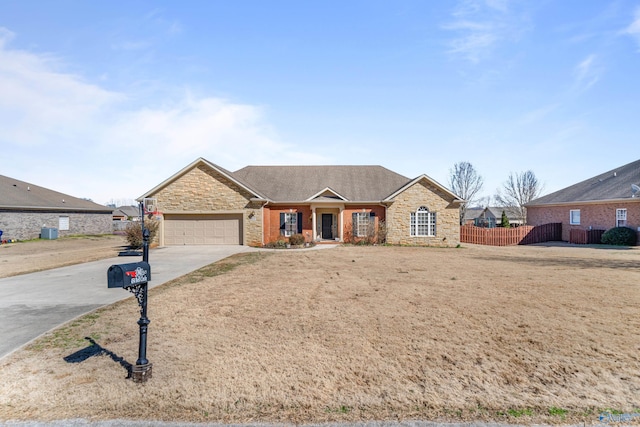 single story home featuring a shingled roof, concrete driveway, stone siding, an attached garage, and fence