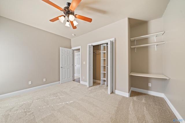 unfurnished bedroom featuring a ceiling fan, carpet, and baseboards