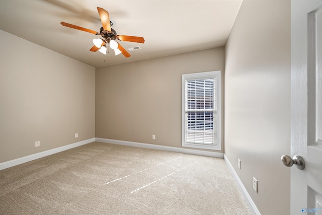 unfurnished room featuring light carpet, baseboards, visible vents, and a ceiling fan