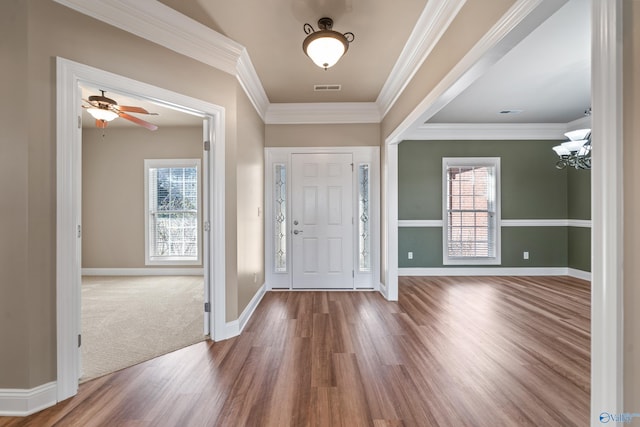 entryway with plenty of natural light, visible vents, and crown molding