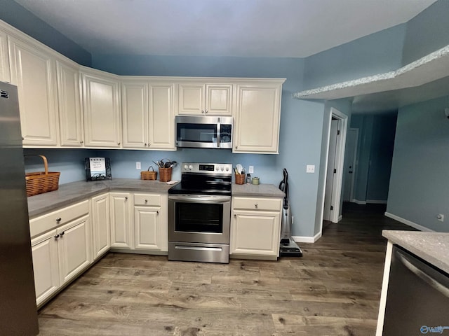 415 County Road 355, Leesburg, AL 35983 - kitchen featuring stainless steel appliances, light wood-style floors, light countertops, and white cabinetry