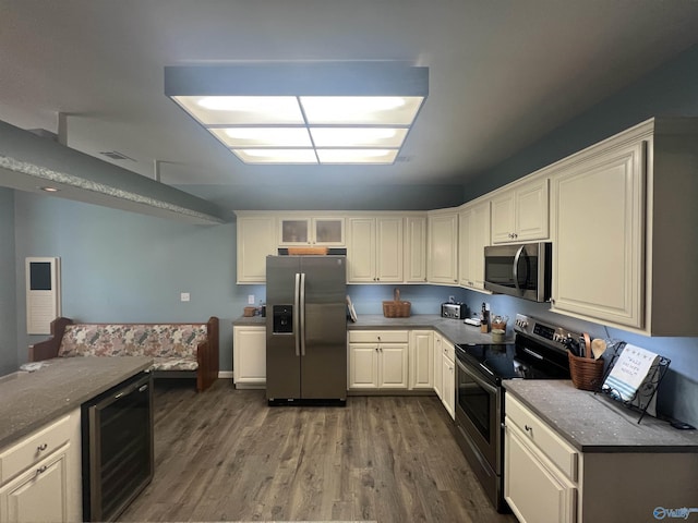 415 County Road 355, Leesburg, AL 35983 - kitchen featuring appliances with stainless steel finishes, wine cooler, wood finished floors, and white cabinetry