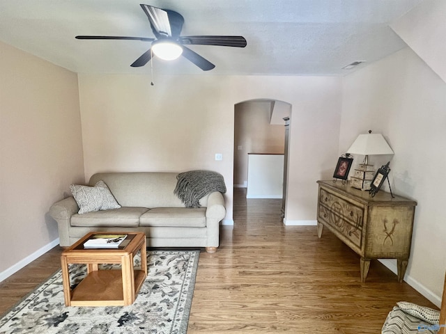 415 County Road 355, Leesburg, AL 35983 - living area with arched walkways, ceiling fan, and wood finished floors