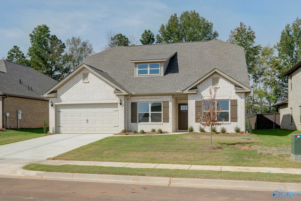 craftsman-style home with a front yard, concrete driveway, brick siding, and an attached garage