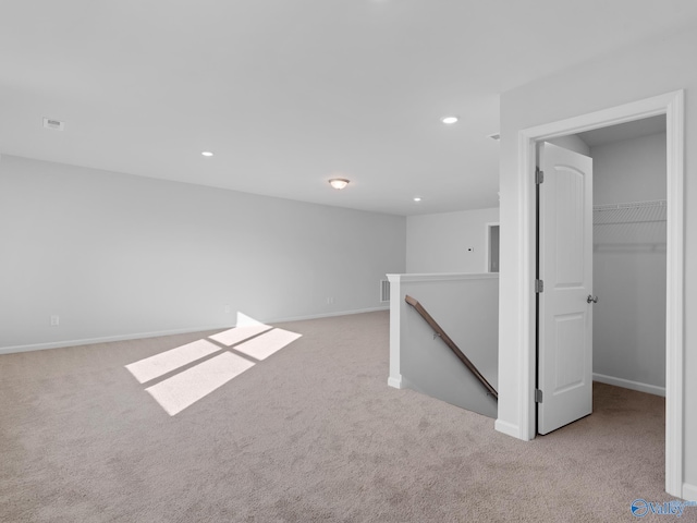 basement featuring light colored carpet