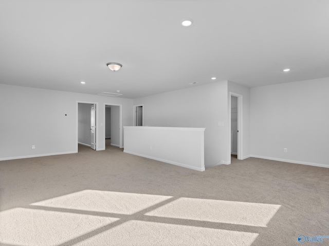 unfurnished living room featuring light colored carpet