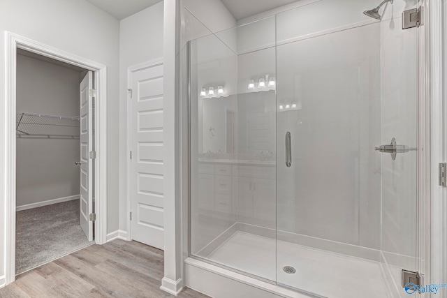 bathroom featuring hardwood / wood-style flooring and a shower with door