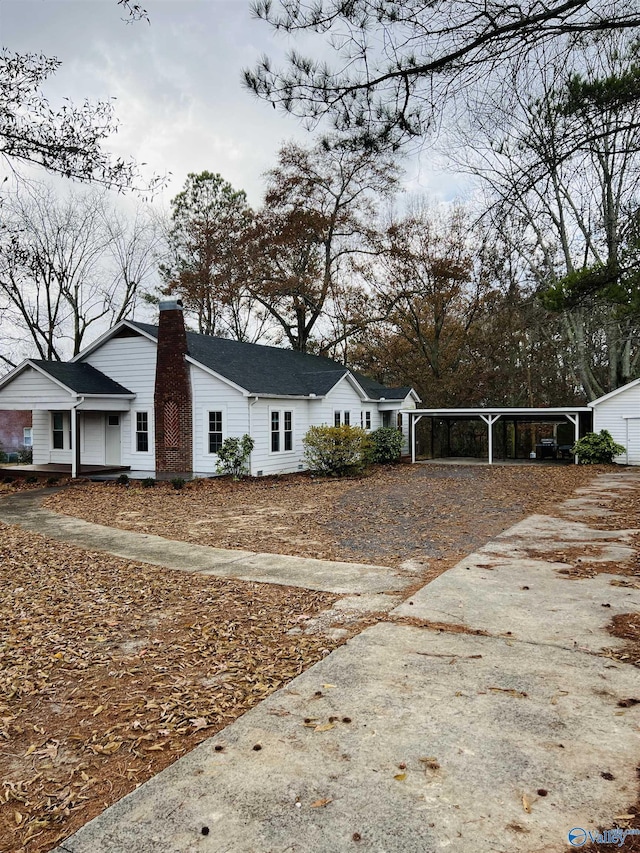 view of side of home with a carport