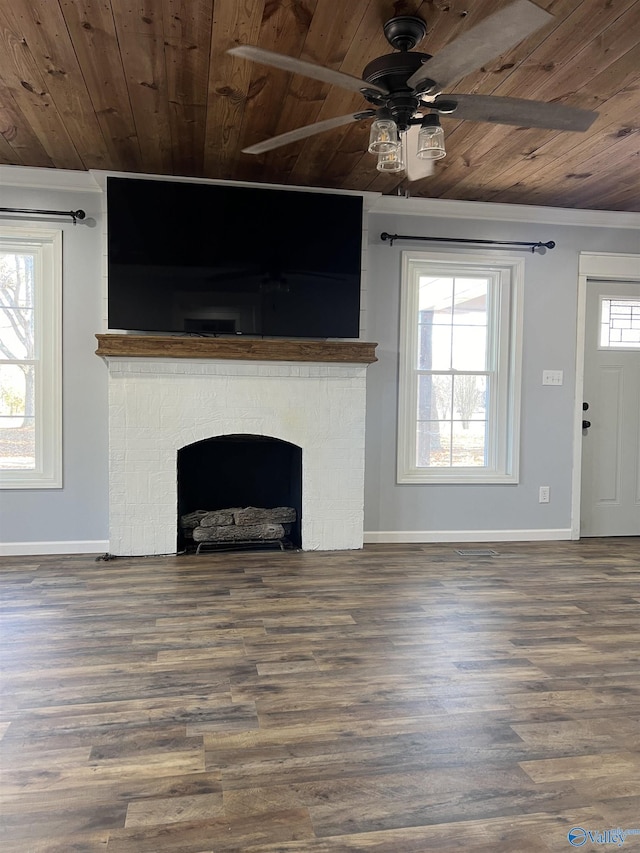 unfurnished living room with a fireplace, plenty of natural light, wood ceiling, and wood-type flooring