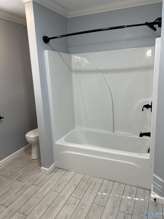 bathroom featuring wood-type flooring,  shower combination, toilet, and crown molding