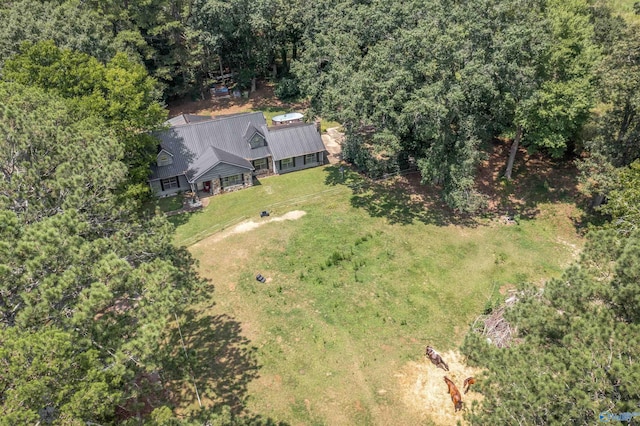 drone / aerial view featuring a forest view