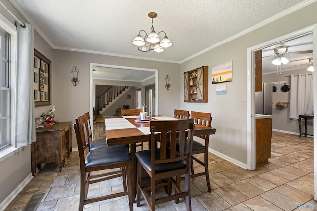 dining room featuring visible vents, baseboards, stairway, a textured ceiling, and crown molding