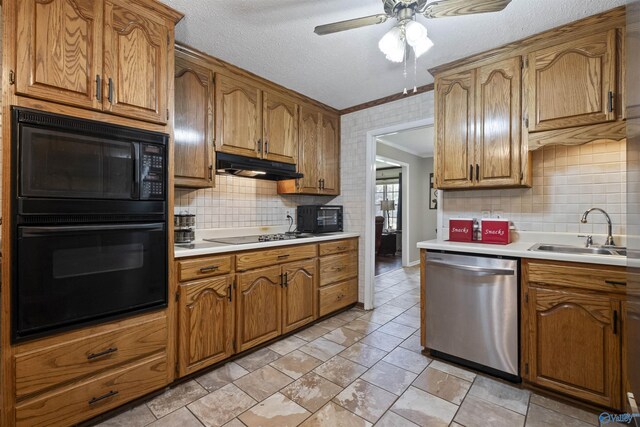 kitchen featuring crown molding, light countertops, a sink, under cabinet range hood, and black appliances