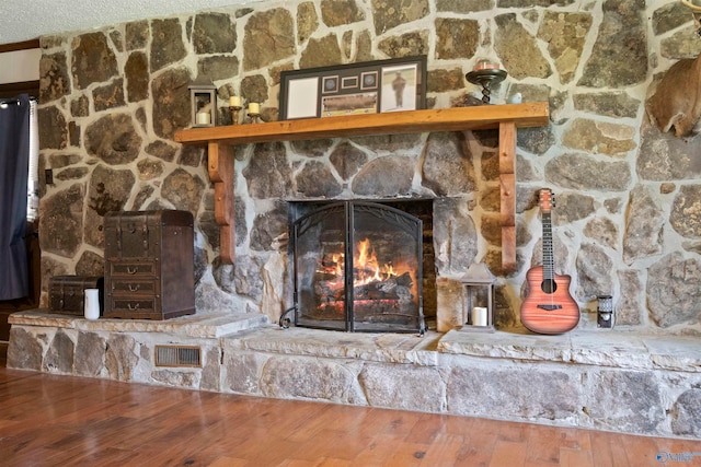 interior details featuring a fireplace and hardwood / wood-style floors