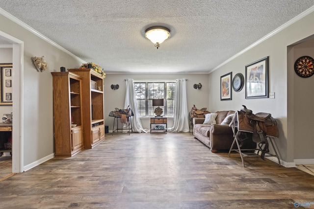 interior space with ornamental molding, wood finished floors, and baseboards