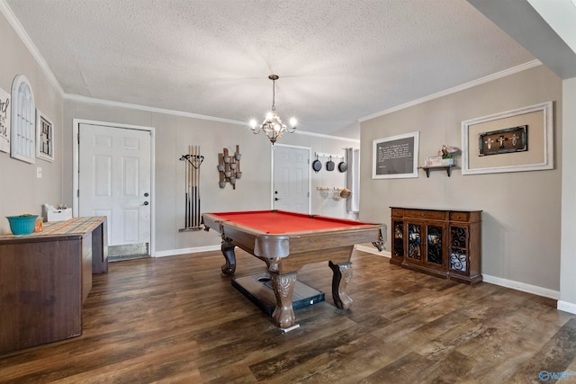 game room with a textured ceiling, a chandelier, billiards, ornamental molding, and dark hardwood / wood-style flooring