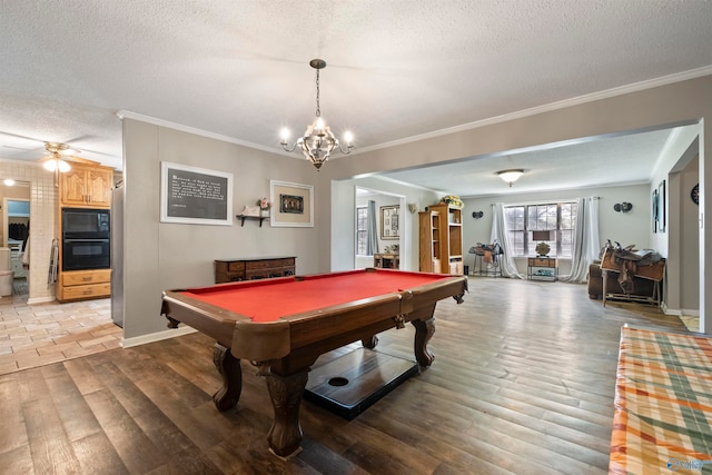 playroom with ceiling fan with notable chandelier, pool table, a textured ceiling, and wood-type flooring