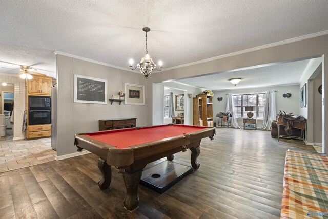 recreation room featuring light wood-style floors, ornamental molding, a textured ceiling, and ceiling fan