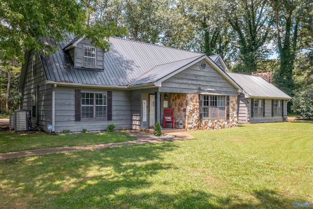 view of front facade with a front lawn and central AC