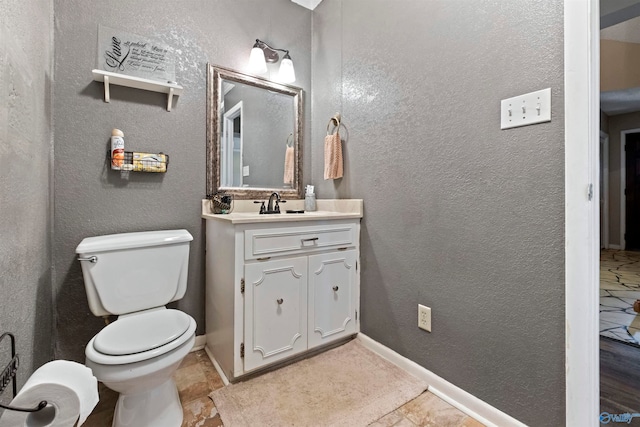 bathroom featuring tile patterned floors, vanity, and toilet