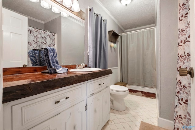 bathroom featuring a textured ceiling, toilet, ornamental molding, tile patterned flooring, and vanity