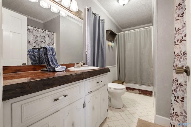 bathroom with ornamental molding, a textured ceiling, vanity, and tile patterned floors