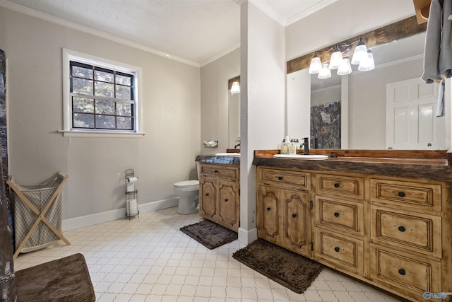 bathroom with baseboards, toilet, vanity, a textured ceiling, and crown molding