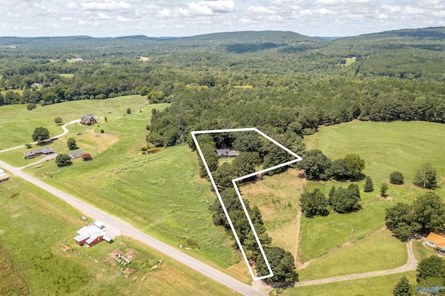 birds eye view of property featuring a rural view and a view of trees