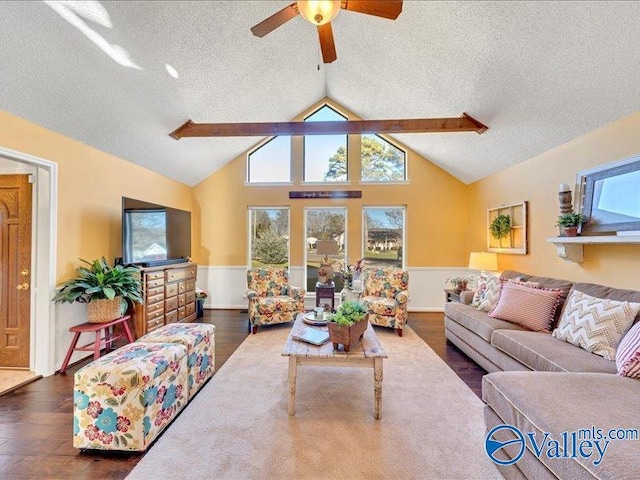 living room featuring lofted ceiling with beams, ceiling fan, dark wood-type flooring, and a textured ceiling