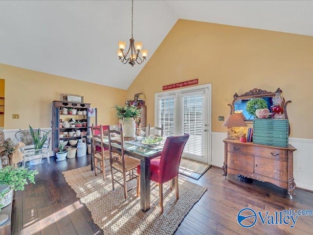 dining area featuring dark hardwood / wood-style flooring, high vaulted ceiling, and a notable chandelier