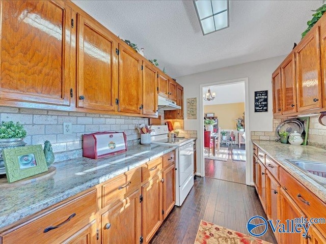 kitchen with tasteful backsplash, a textured ceiling, light stone counters, and white range with electric cooktop
