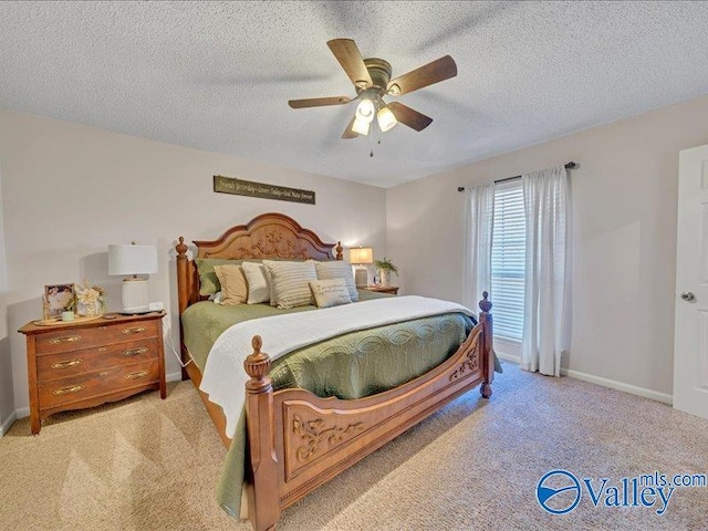carpeted bedroom featuring a textured ceiling and ceiling fan