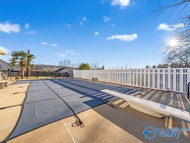 view of swimming pool with a patio