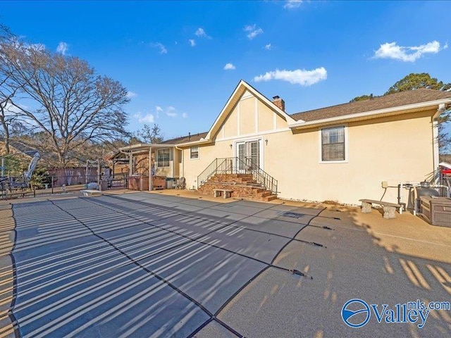 back of property with a patio