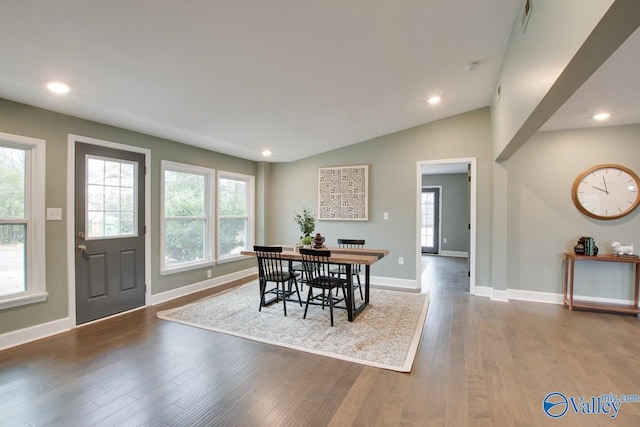 dining room with hardwood / wood-style flooring and lofted ceiling