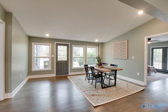 dining room with vaulted ceiling, dark wood-type flooring, and french doors