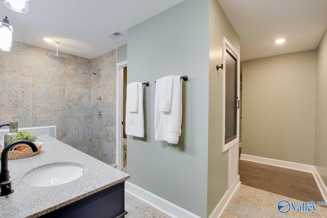 bathroom with vanity and a shower