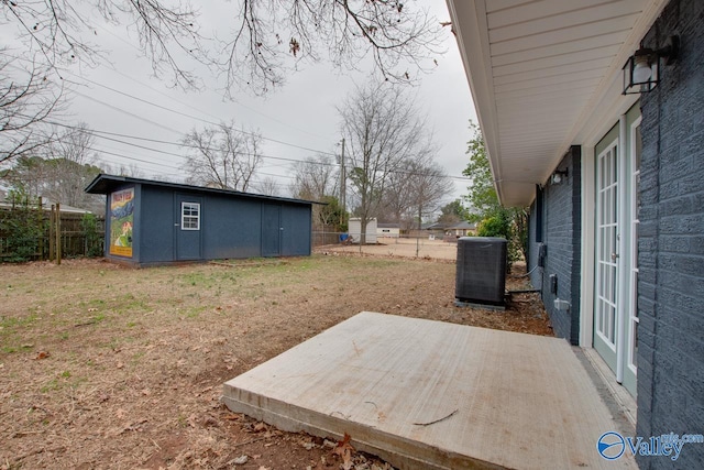 view of yard featuring an outbuilding, a patio area, and cooling unit