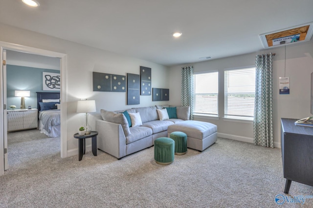 living room with recessed lighting, light colored carpet, and baseboards