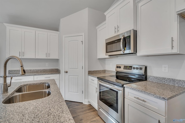 kitchen featuring a sink, appliances with stainless steel finishes, and white cabinets