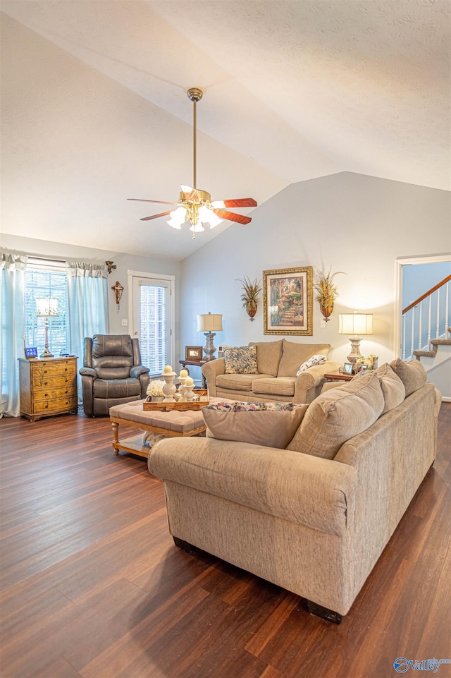 living room with lofted ceiling, ceiling fan, and dark hardwood / wood-style floors