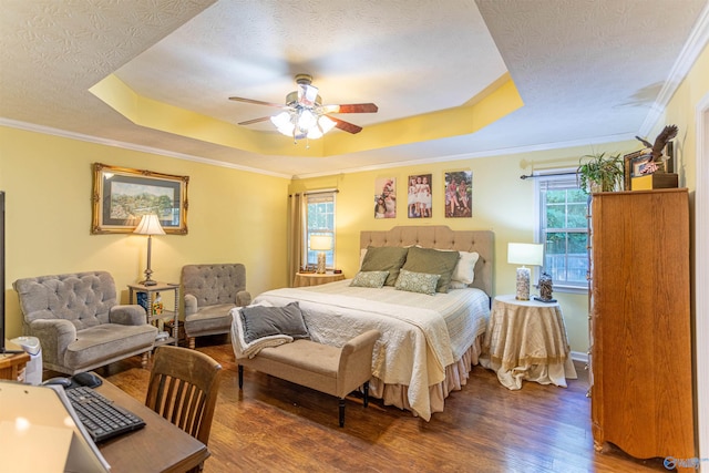 bedroom with a textured ceiling, crown molding, dark hardwood / wood-style flooring, and ceiling fan