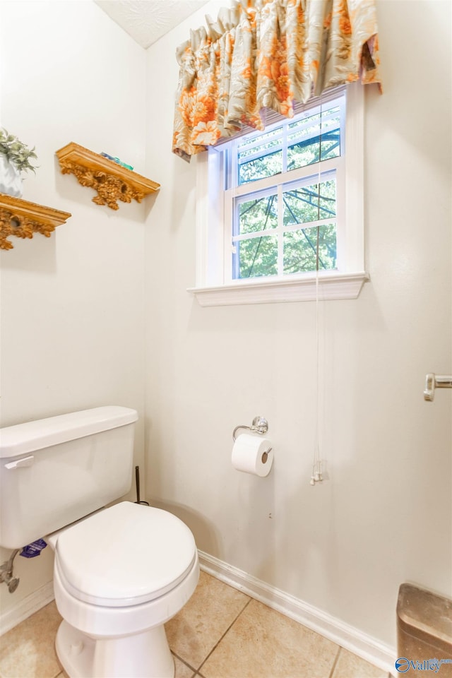 bathroom with tile patterned flooring and toilet