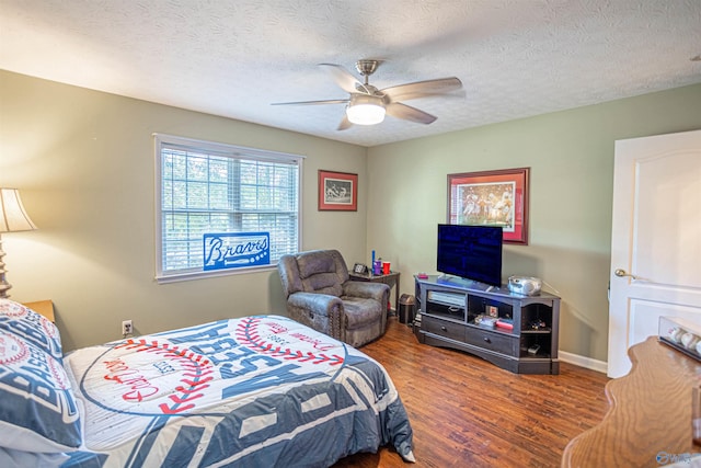 bedroom featuring a textured ceiling, dark wood-type flooring, and ceiling fan