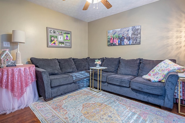 living room featuring a textured ceiling, ceiling fan, and hardwood / wood-style flooring